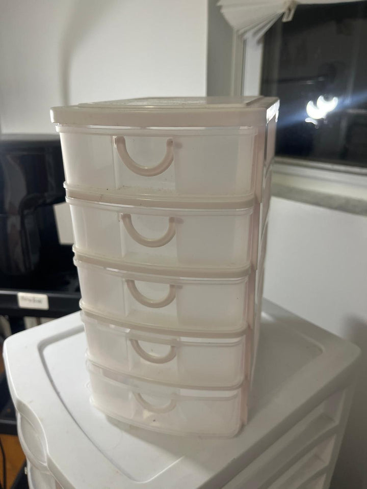 White plastic organizer with five clear slide-out drawers