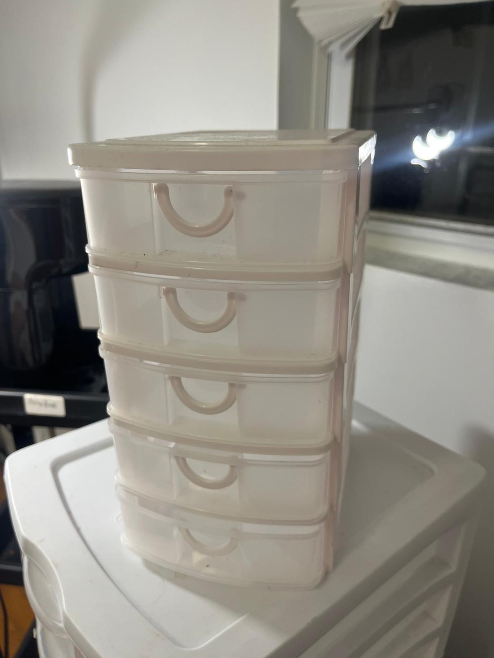 White plastic organizer with five clear slide-out drawers